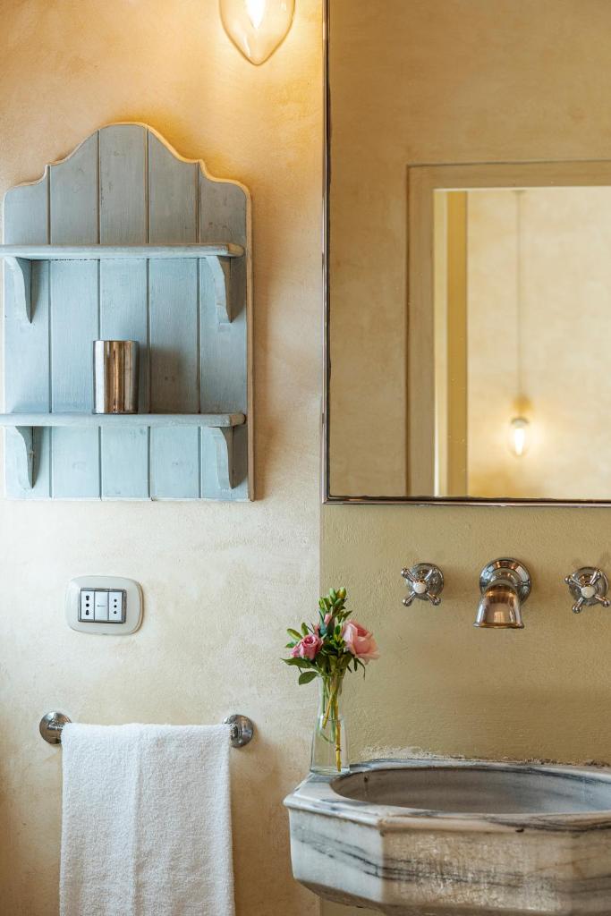 une salle de bain avec un lavabo et un miroir dans l'établissement L'Oliveta 6, Emma Villas, à Gambassi Terme 21 autres photos