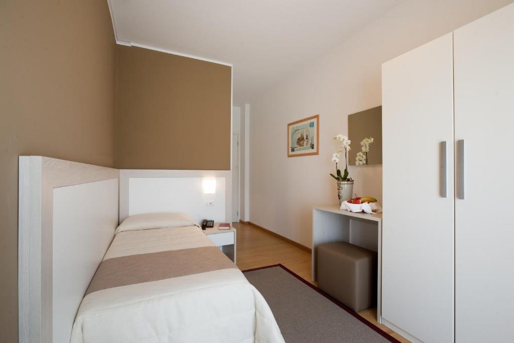 une chambre d'hôtel avec deux lits et un miroir dans l'établissement Hotel Canarie, à Lido di Jesolo