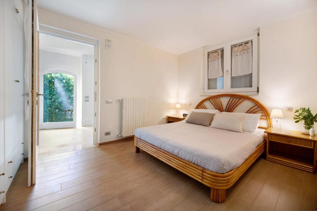 une chambre avec un grand lit et un parquet dans l'établissement Villa Savi Lake View and Pool, à Torri del Benaco