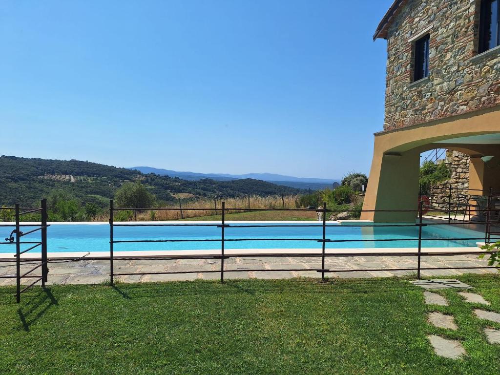 une piscine dans la cour d'une maison dans l'établissement Villa le Sughere - Privacy, Piscina e Vista Panoramica, à Castellina Marittima