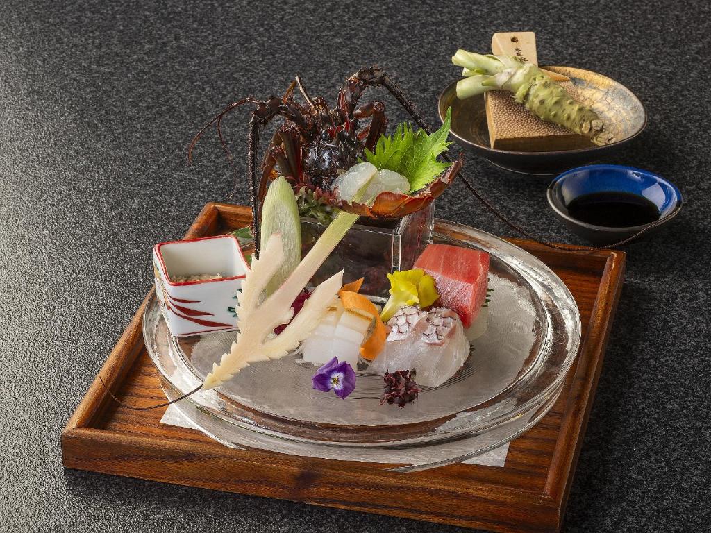 un plateau avec une assiette de nourriture sur une table dans l'établissement Shimoda Central Hotel, à Shimoda