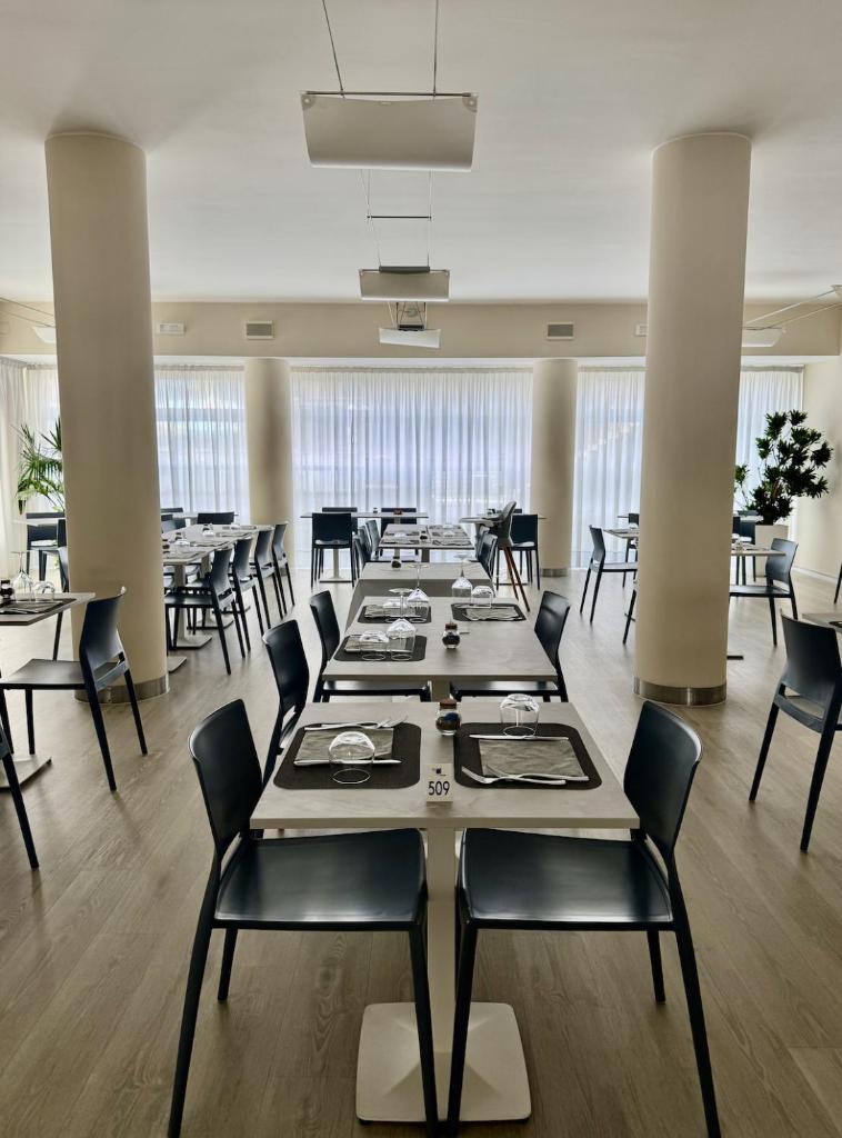 une grande salle à manger avec une longue table et des chaises dans l'établissement Hotel Rosanna 3 Stelle Superior, à Lido di Jesolo 41 autres photos