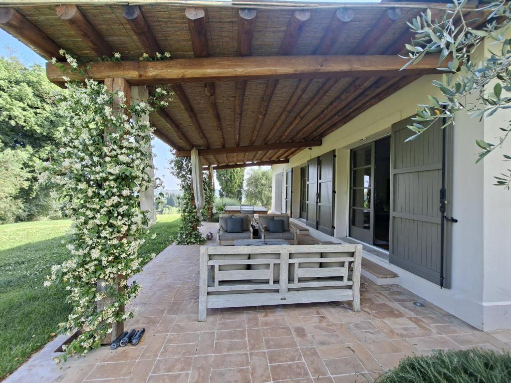 un patio extérieur avec une pergola en bois dans l'établissement Il Poggio - Luxury villa in Tuscany, à Cetona