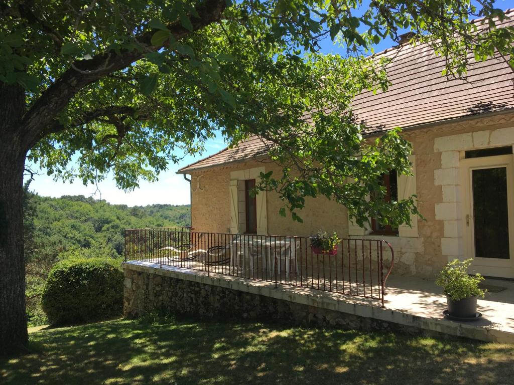 une maison avec une clôture et un arbre dans l'établissement Les Gîtes de JueVince, à Issac