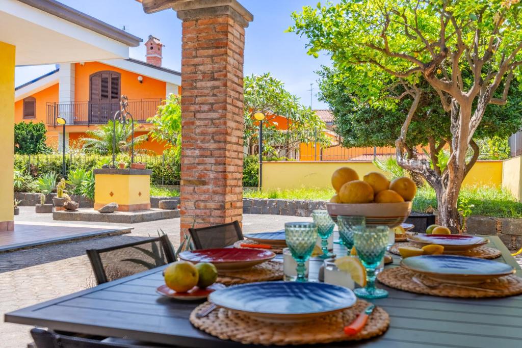 - une table en bois avec un bol de fruits dans l'établissement Villa Cesare, à Mascali