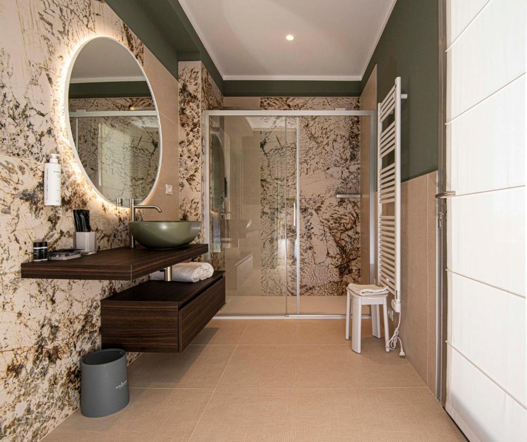une salle de bain avec un lavabo et un miroir dans l'établissement Hotel Europa Lignano, à Lignano Sabbiadoro