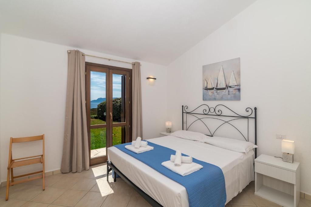 une chambre avec un lit et une grande fenêtre dans l'établissement Villa Daniela, à Olbia