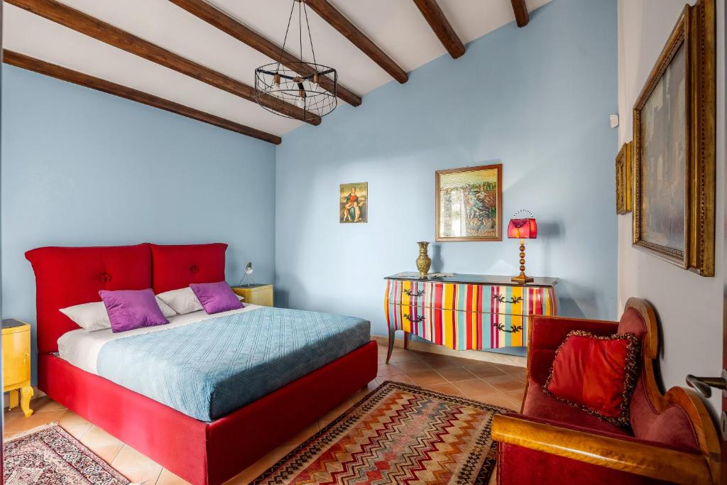 - une chambre avec un lit rouge et une chaise dans l'établissement Cleo - Villa Siciliana, à Partinico 28 autres photos