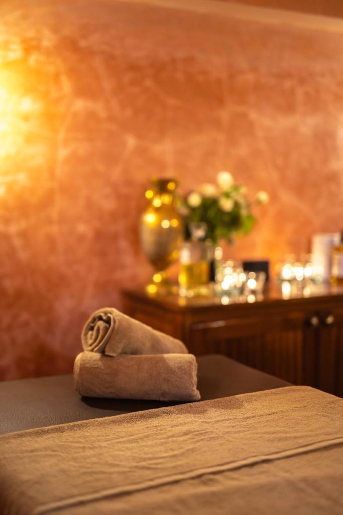 - une serviette enroulée assise au-dessus d'un lit dans l'établissement Alrashid Marrakech - Hotel & SPA, à Marrakech