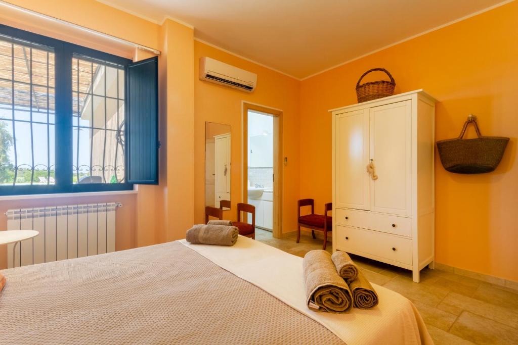 - une chambre avec des murs orange, un lit et une fenêtre dans l'établissement La Rossi with pool Gallipoli 4, à Gallipoli 62 autres photos