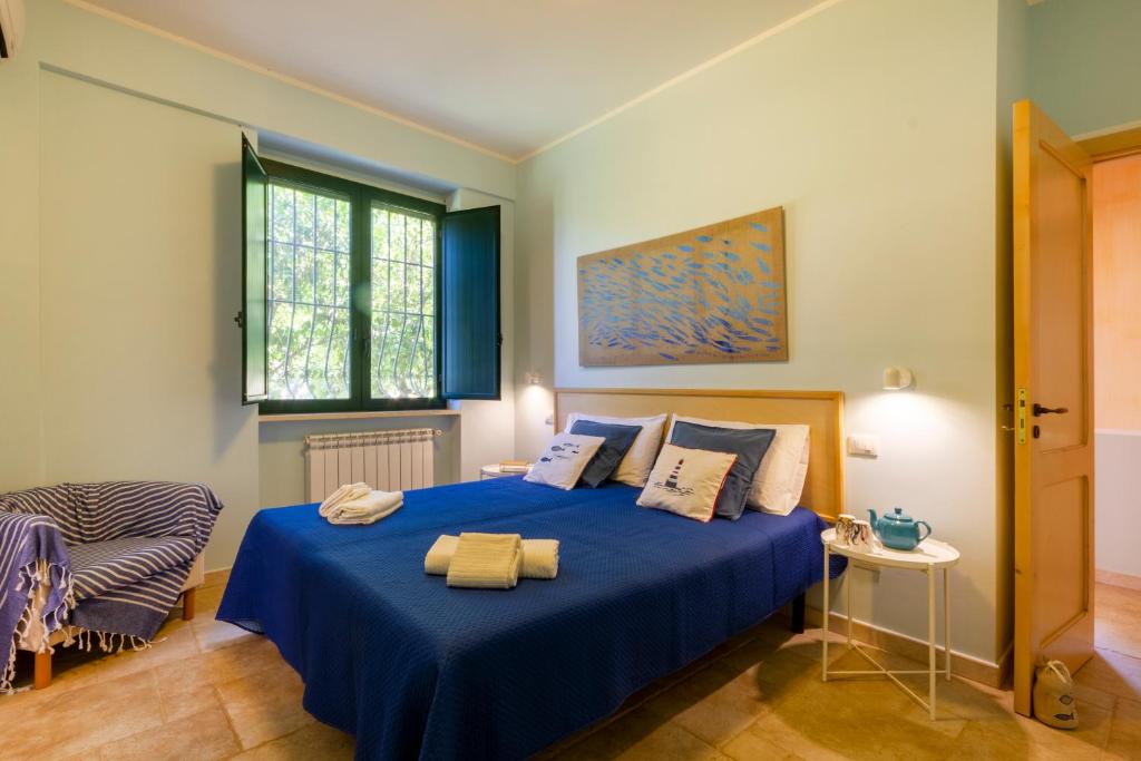 - une chambre avec un lit bleu et une chaise dans l'établissement Country House La Rossi with pool Gallipoli 7, à Gallipoli