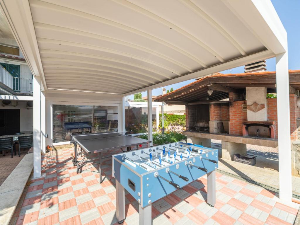 un patio avec une table de ping-pong et un barbecue extérieur dans l'établissement Villa La Rosa by Interhome, à Montelupo Fiorentino