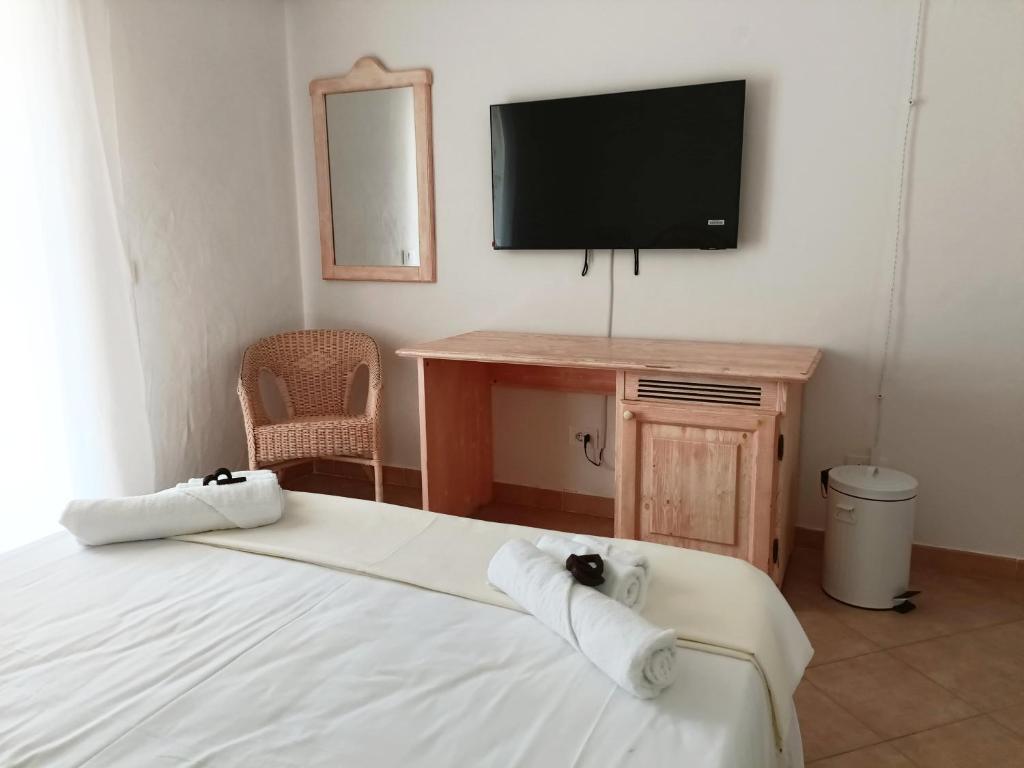 une chambre avec un lit et une télévision à écran plat dans l'établissement Neo Hotel Tre Monti, à Baja Sardinia 12 autres photos