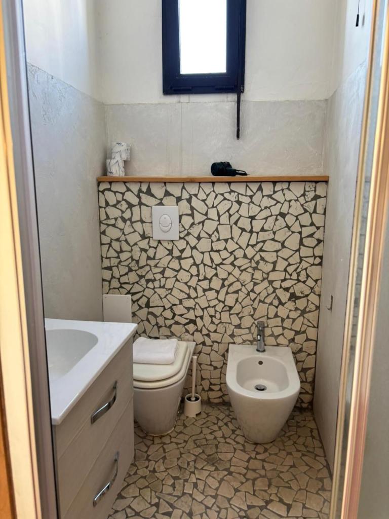 une salle de bain avec toilettes et lavabo dans l'établissement Hotel Garisenda B&B - in Centro a Riccione -, à Riccione
