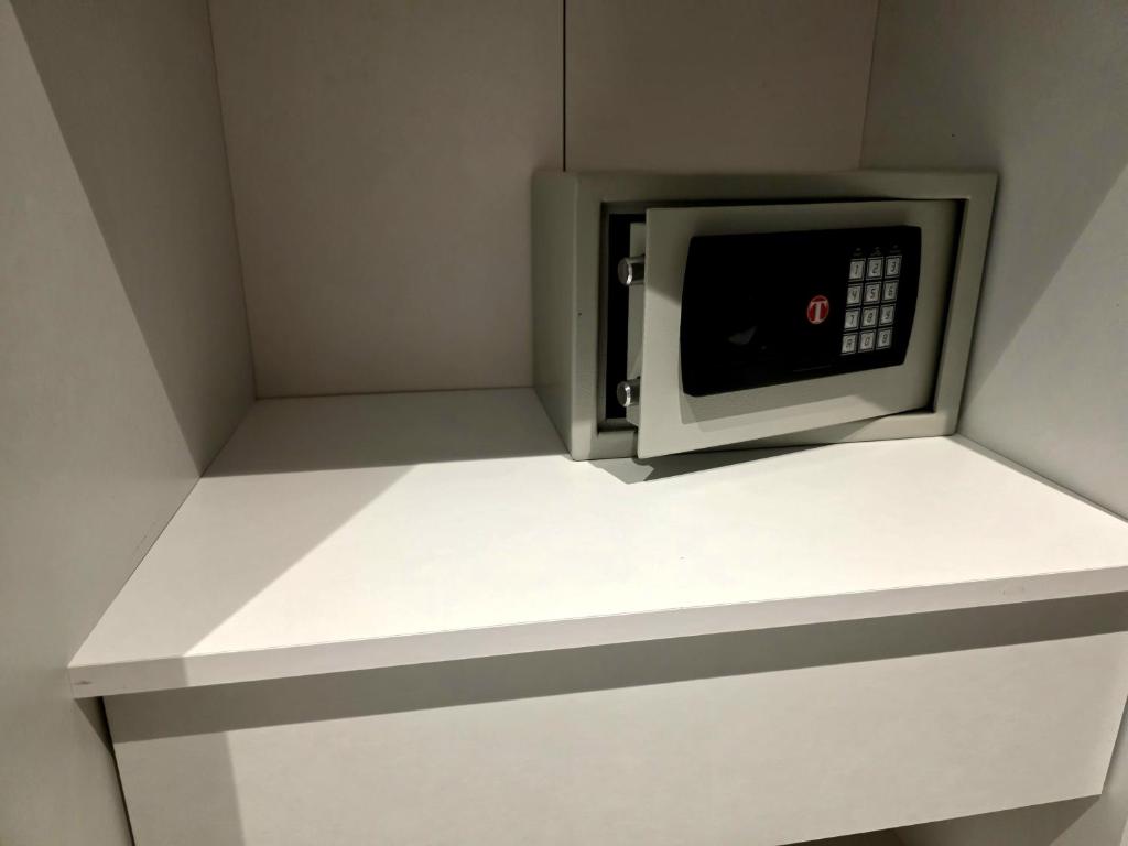 Un four micro-ondes est installé au-dessus d'une étagère blanche. dans l'établissement Sottocoperta, à Roseto degli Abruzzi 12 autres photos