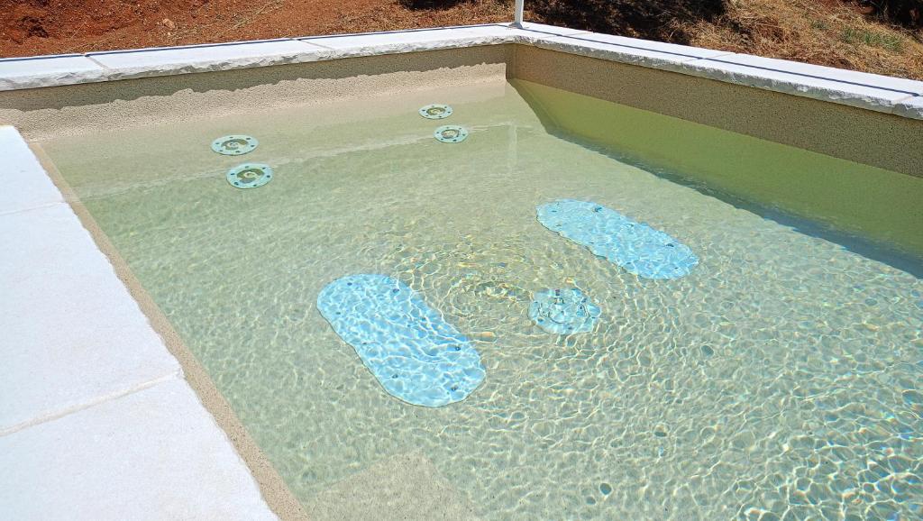 une piscine d'eau avec des chaussures bleues dedans dans l'établissement Small Exclusive Retreat, à Lamezia Terme