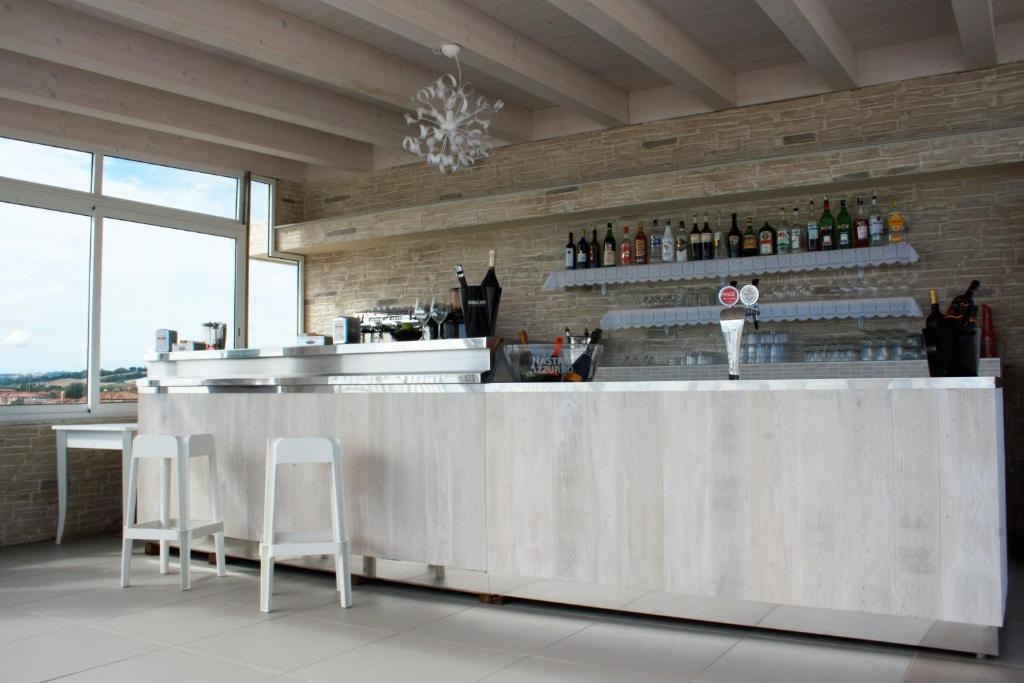 - une cuisine avec un bar avec deux tabourets dans l'établissement GFH - Hotel Sole Resort & Spa, à Marotta