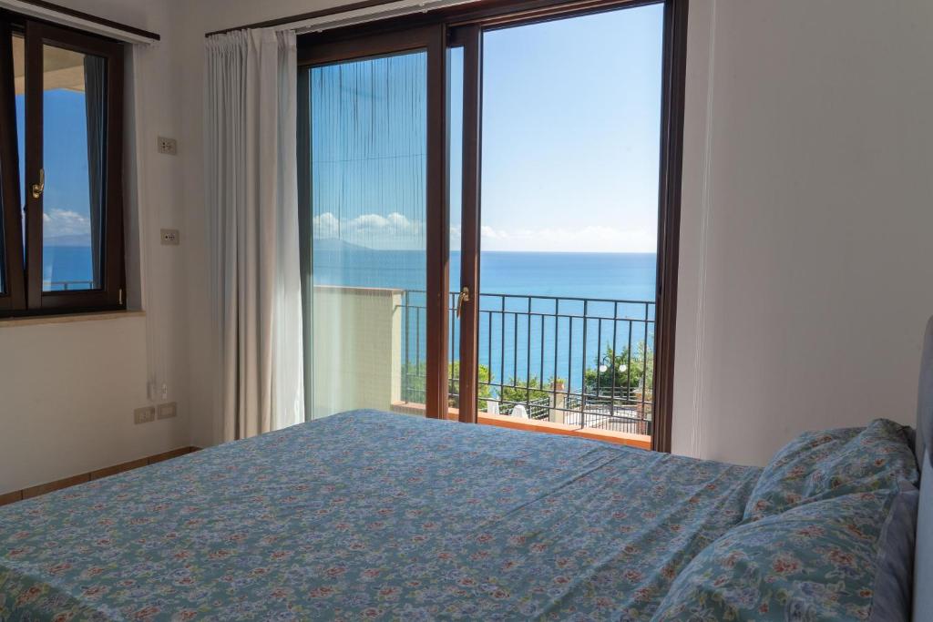 une chambre avec un lit et une vue sur l'océan dans l'établissement Villa Vale - with private pool and sea view, à Capo dʼOrlando