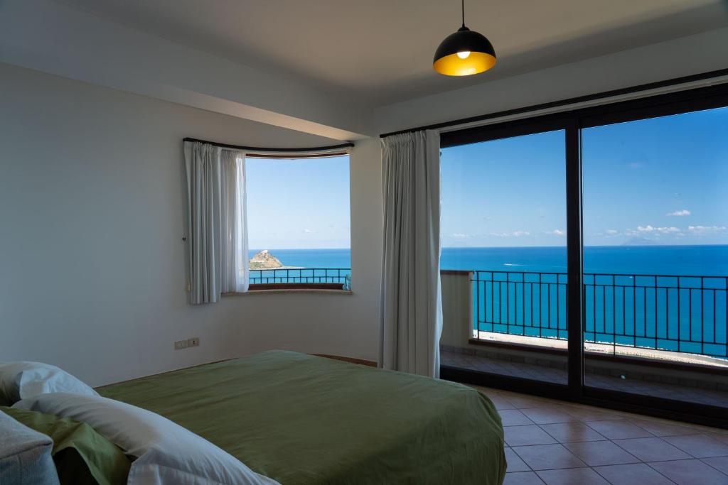une chambre avec un lit et une vue sur l'océan dans l'établissement Villa Vale - with private pool and sea view, à Capo dʼOrlando