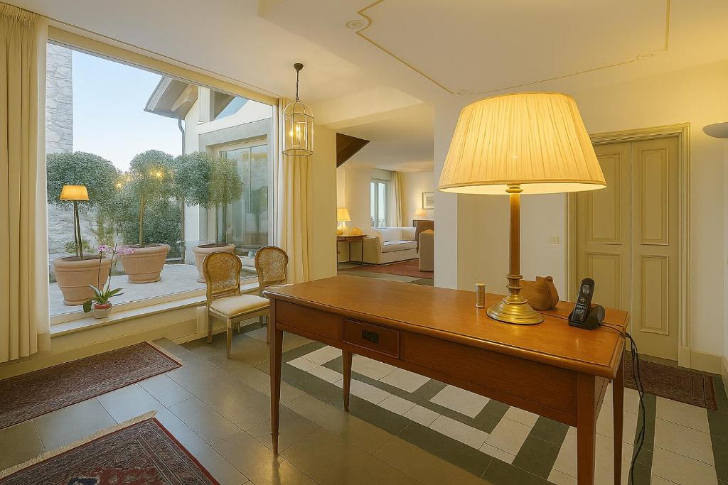 un bureau avec un bureau et une lampe dans l'établissement Green Hill Property, à Besozzo