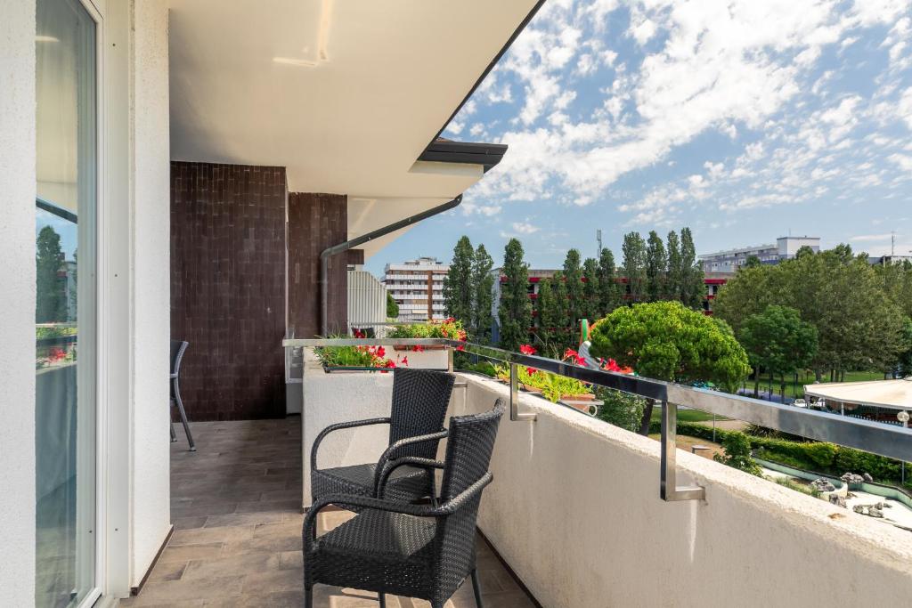 - deux chaises assises sur le balcon d'une maison dans l'établissement Hotel Consuelo, à Lignano Sabbiadoro