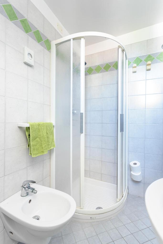 une salle de bain blanche avec une douche et un lavabo dans l'établissement Hotel Dell'Angelo, à Rimini 21 autres photos