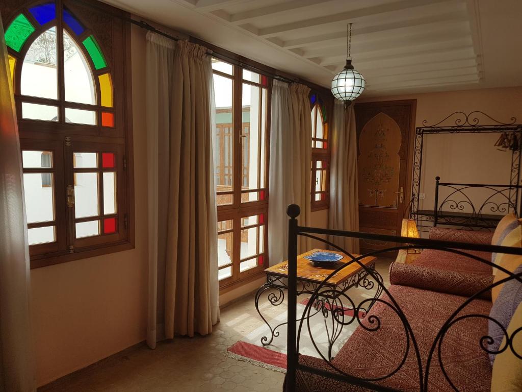 Cette chambre comprend un lit et un vitrail. dans l'établissement Riad Dar Karima, à Rabat