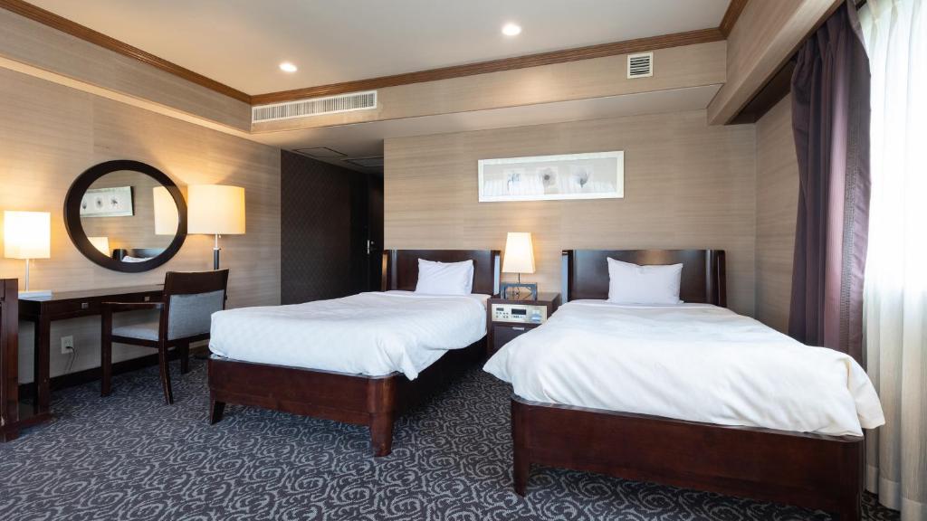 Un ou plusieurs lits dans un hébergement de l'établissement Atami Season Hotel