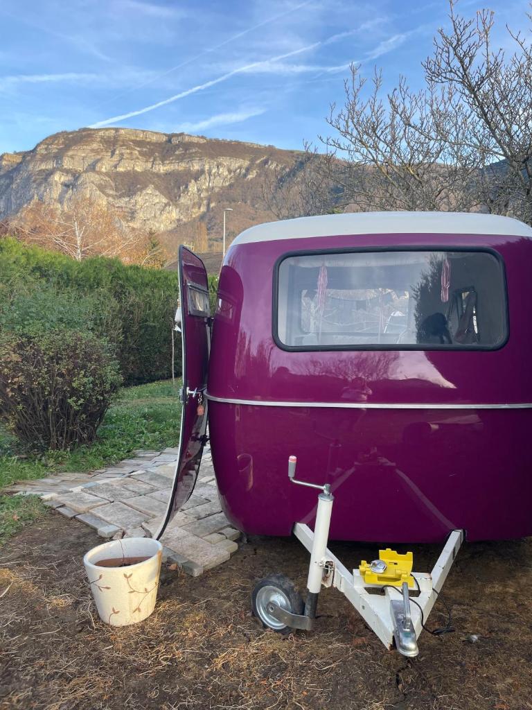 une vieille voiture violette garée dans un champ dans l'établissement Salève Glamping, à Archamps