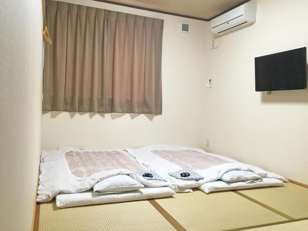 une chambre à l'hôpital avec un lit et des serviettes. dans l'établissement Onsenminshuku Kosakaya, à Nachikatsuura 37 autres photos