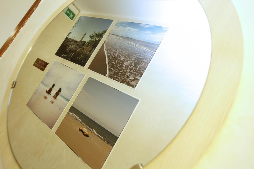 - un miroir avec des photos de la plage et de l'océan dans l'établissement Hotel Villa dei Fiori - sul mare con piscina, à Rimini
