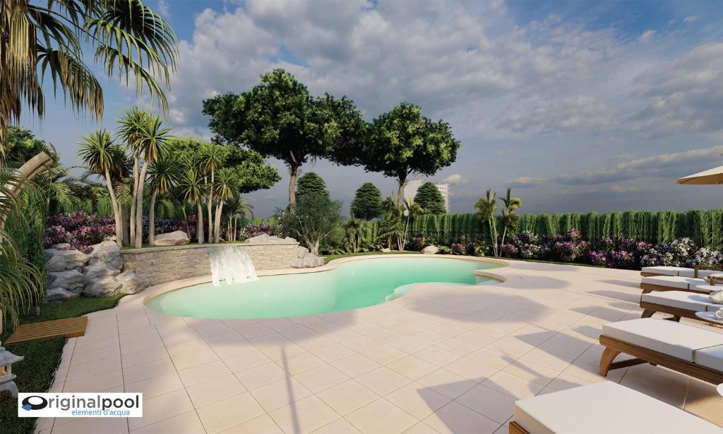 une piscine dans un jardin planté de palmiers dans l'établissement Hotel Maxim, à Caorle