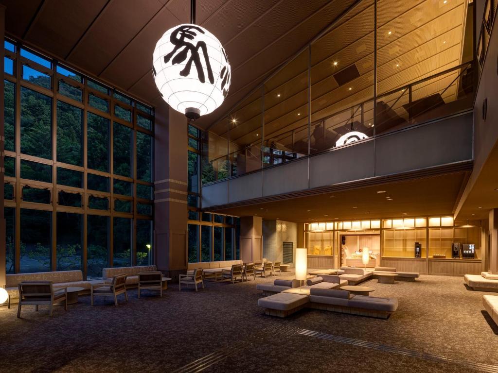 un hall d'un immeuble avec des canapés et une cheminée dans l'établissement KAMENOI HOTEL Arima, à Kobe