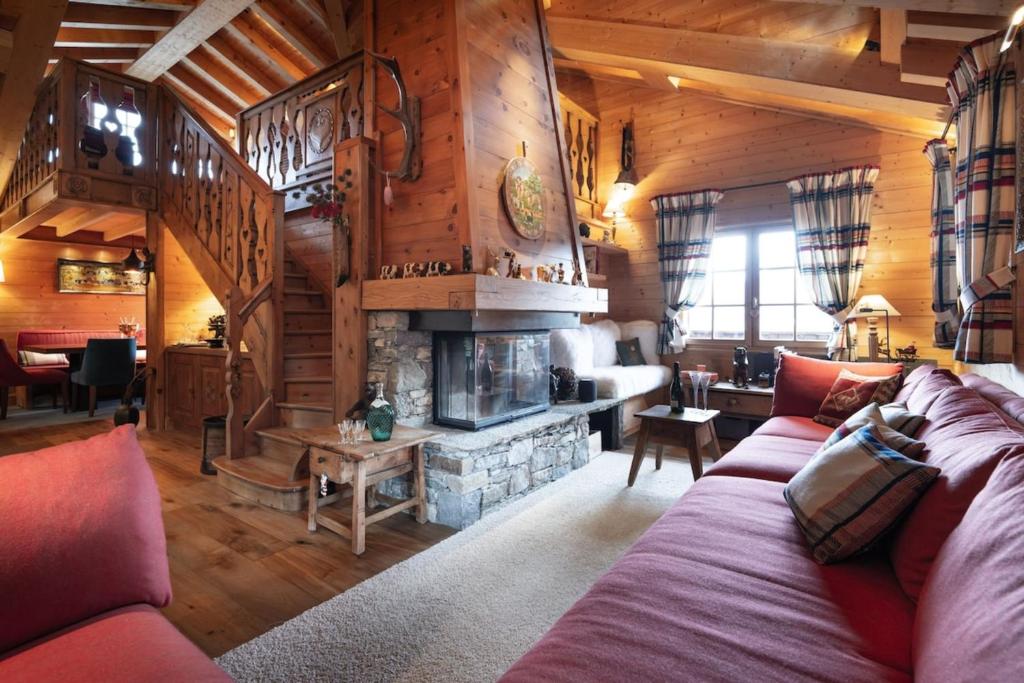 un salon avec un canapé et une cheminée dans l'établissement Chalet Joseph, à Courchevel