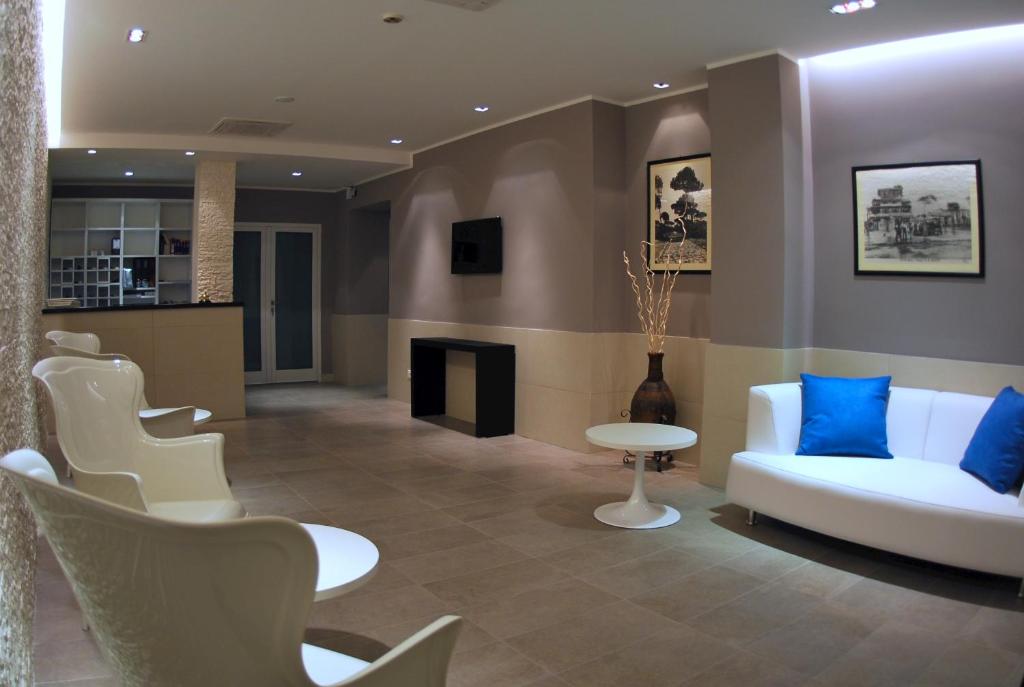 un salon avec un canapé blanc et une cheminée dans l'établissement Hotel La Scaletta, à Lido di Ostia