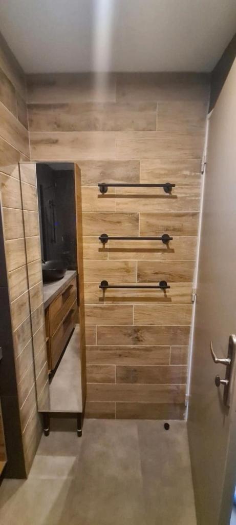 une pièce avec des murs en bois et une porte avec une télévision dans l'établissement Crests Lodge - Plagne -Villages 2100m - Classé 4 étoiles, à La Plagne Tarentaise