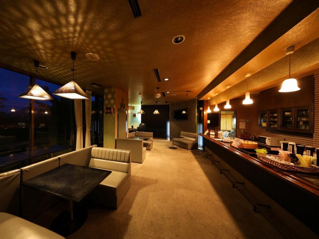 un salon avec un canapé et un bar dans l'établissement Sasakura onsen Ryuunso, à Itoigawa
