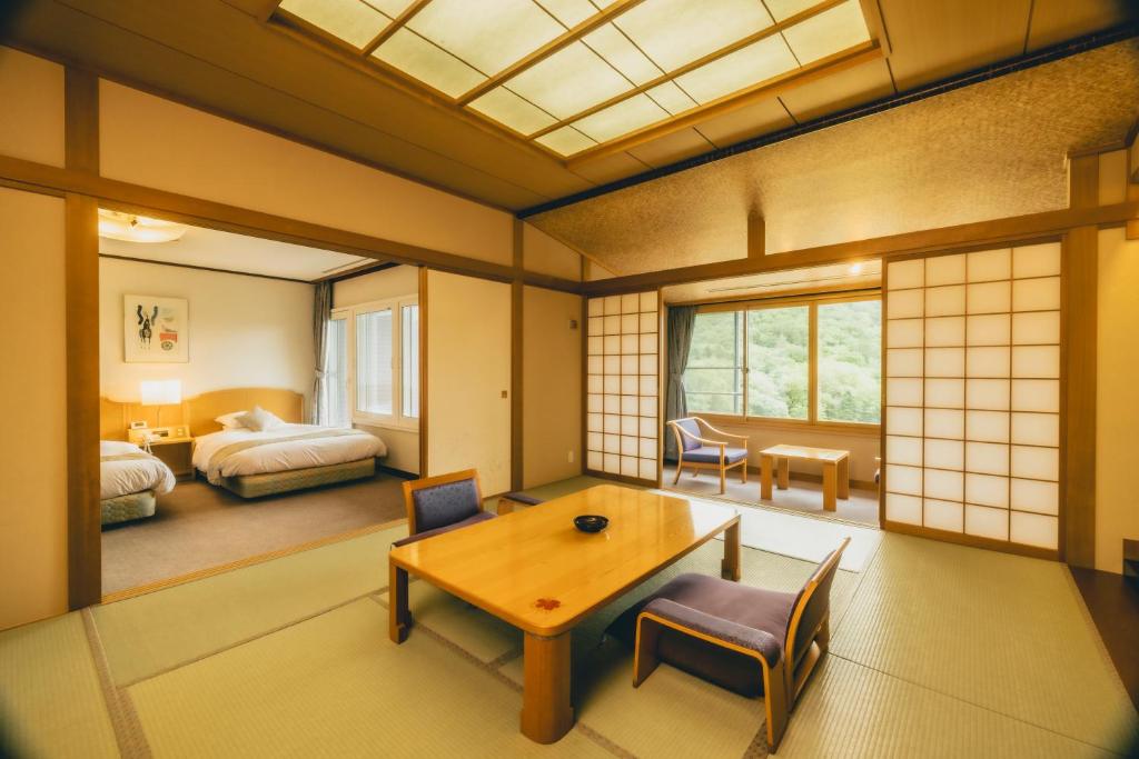 un salon avec une table et une chambre dans l'établissement Oehonke, à Kitami