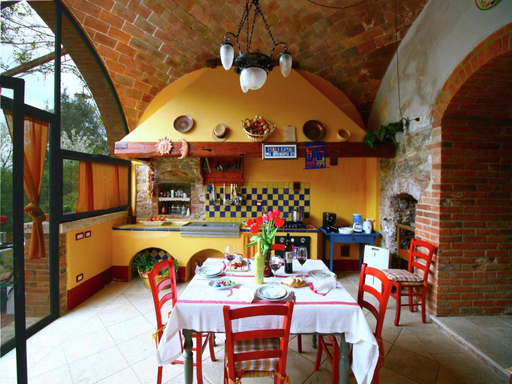 une salle à manger avec une table et des chaises dans une cuisine dans l'établissement Elegant Villa in Tuscany, à Rapolano Terme