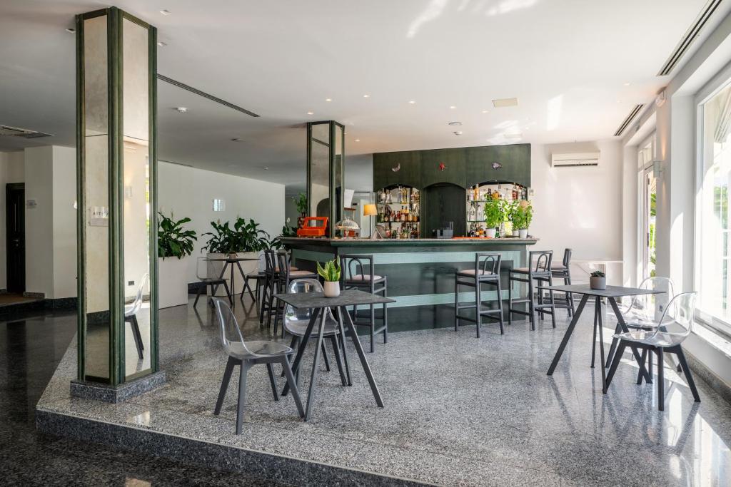 une pièce avec des tables et des chaises et une cuisine dans l'établissement Hotel Riva Del Sole, à Giovinazzo