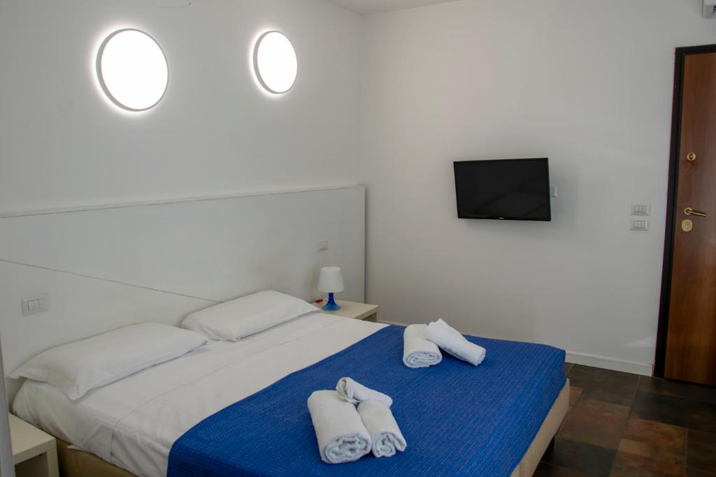 une chambre avec un lit avec des serviettes dessus dans l'établissement Regent Beachotel, à Reggio de Calabre 27 autres photos