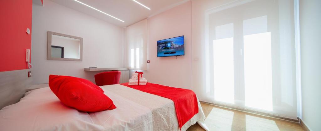 Un ou plusieurs lits dans un hébergement de l'établissement Palazzo Fiorentini Charme Hotel