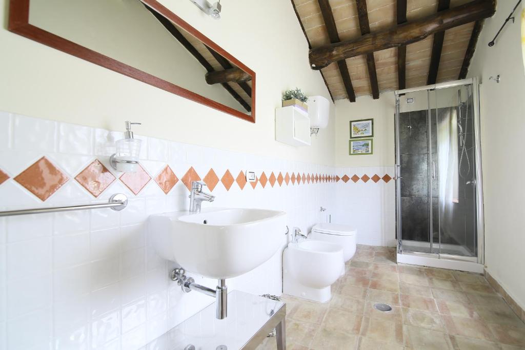 La salle de bains est pourvue d'un lavabo et de 2 toilettes. dans l'établissement CASALE SANTA CATERINA Jacuzzi and Pool, à Collazzone