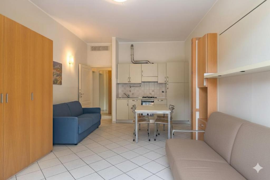 un salon avec un canapé bleu et une table dans l'établissement Residenza al Porto, à Spotorno