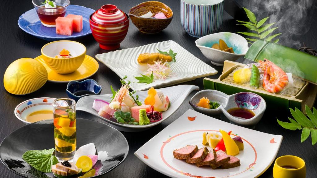 une table avec des assiettes et des bols de nourriture dans l'établissement Ryuguden, à Hakone
