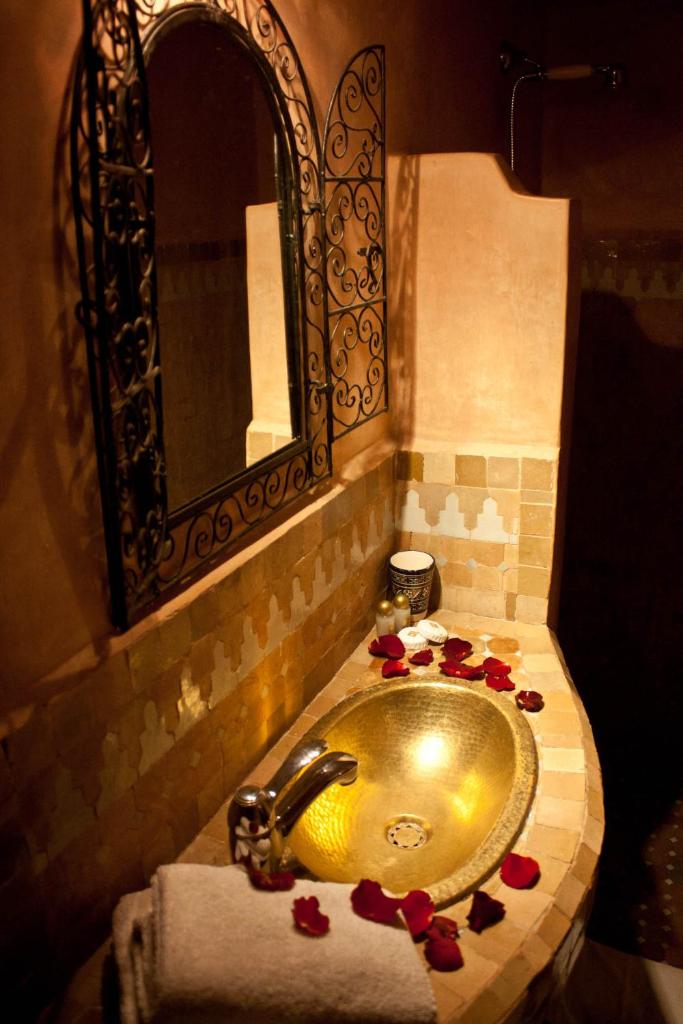 La salle de bains est pourvue d'un lavabo et de roses rouges. dans l'établissement Riad Tayba, à Fès 37 autres photos