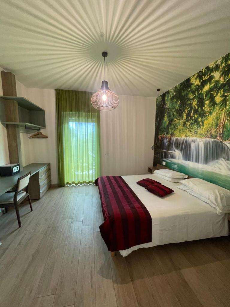 une chambre avec un lit avec un tableau sur le mur dans l'établissement Suite du Parc & Hotel, à Giulianova 33 autres photos