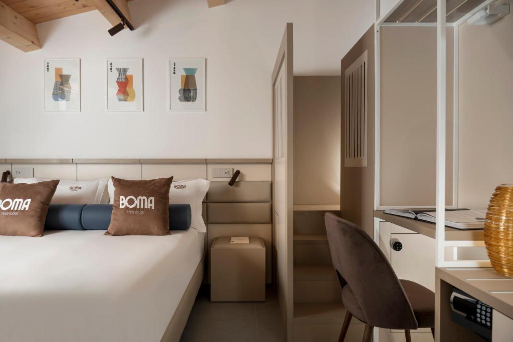 une chambre d'hôtel avec un lit et une chaise dans l'établissement BOMA Prime Rooms, à Civitanova Marche