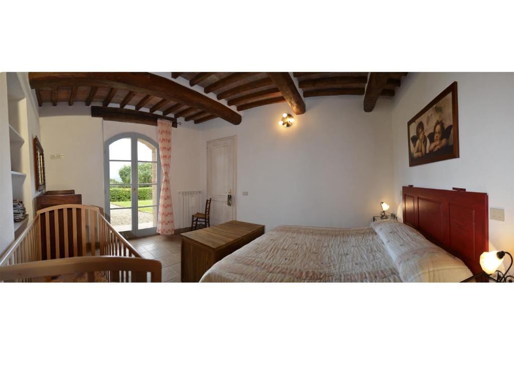 une chambre avec un grand lit et un escalier dans l'établissement Villa le Capanne, à Montecastelli