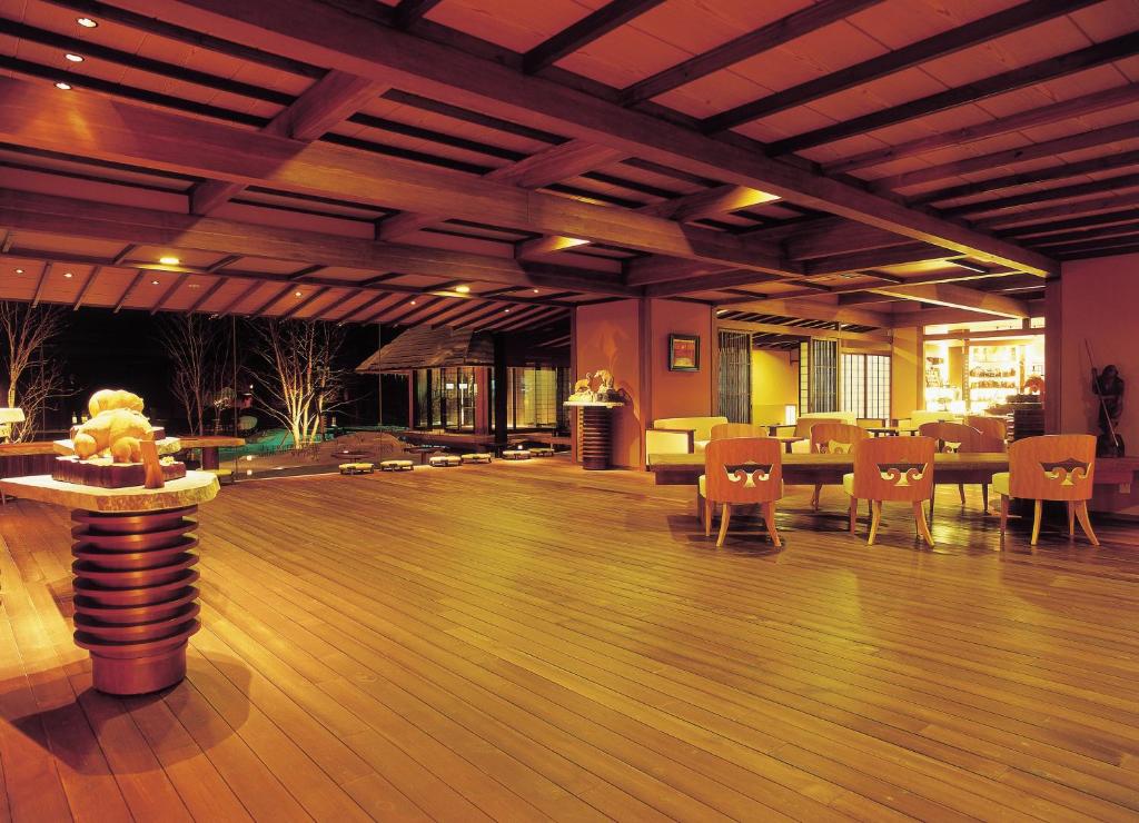 Cette grande chambre dispose de parquet, de tables et de chaises. dans l'établissement Akan Tsuruga Besso Hinanoza, à Akankohan